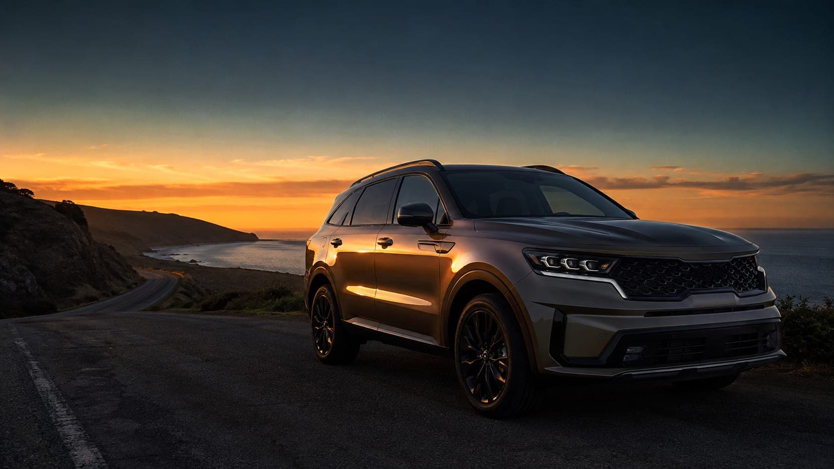 A luxury SUV parked on a coastal road at sunset